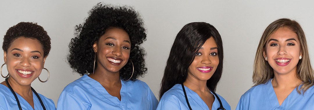 Four nurses smiling